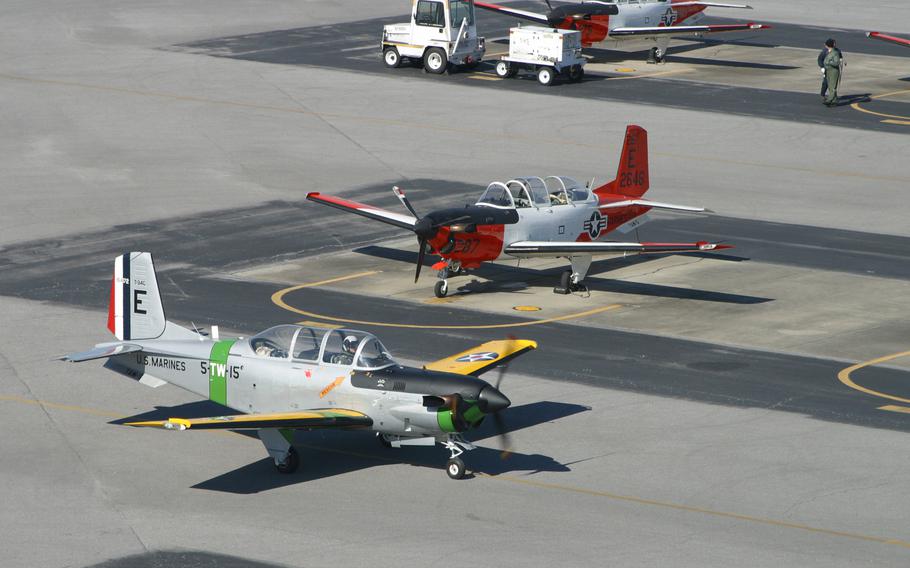 A unique T-34 “Turbo Mentor” passes in front of several other T-34’s painted in the current orange and white colors. The T-34 Association has scheduled its T-34 Mentor fly-in and flyovers at the Wright-Patterson Air Force Base museum beginning Friday afternoon, June 9, 2023, the museum has announced.