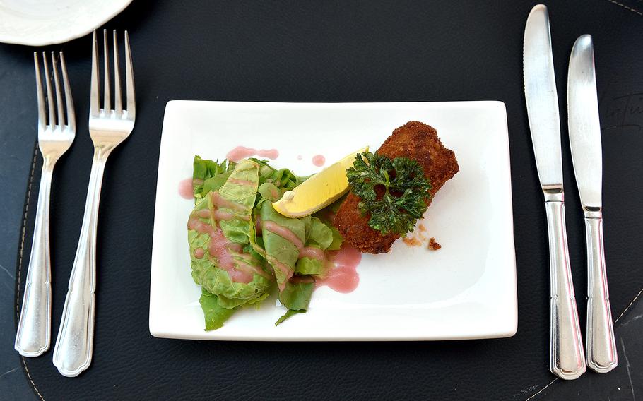 The shrimp croquette served at L'intuition in Houdeng-Aimeries, Belgium, on Aug. 27, 2024, was served with lettuce and a raspberry vinaigrette dressing. Patrons also could order two croquettes as an appetizer.