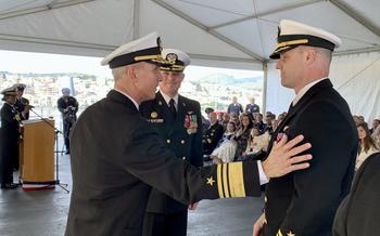 Vice Adm. Jeffrey Anderson, commander of U.S. 6th Fleet and Naval Striking and Support Forces NATO, left, speaks with Capt. Colin Price, new commander of USS Mount Whitney.