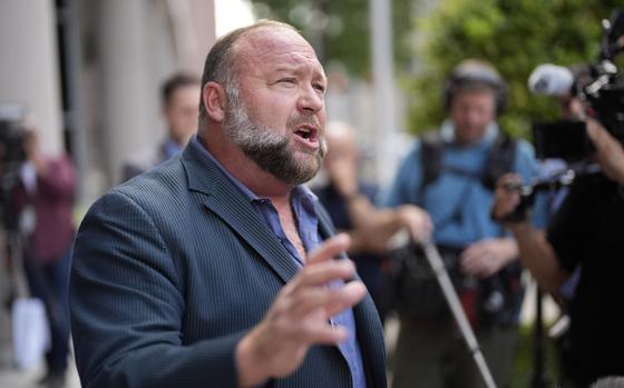 FILE - Right-wing conspiracy theorist Alex Jones speaks to the media after arriving at the federal courthouse for a hearing in front of a bankruptcy judge, Friday, June 14, 2024, in Houston. (AP Photo/David J. Phillip, File)