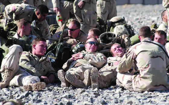 FOB Lagman, Afghanistan, Mar. 20, 2006: Soldiers of the 173rd Airborne Battalion's 2nd Battalion, 503rd Infantry Regiment relax on the helicopter landing pad at Forward Operating Base Lagman, Afghanistan as they wait for a Chinook helicopter ride to Kandahar Air Field on the first leg of their trip home to Vicenza, Italy after a year deployment to Operation Enduring Freedom.

META DATA:  Operation Enduring Freedom; Wars on Terror; taliban; Afghanistan; U.S. Army;  173rd Airborne Battalion's 2nd Battalion, 503rd Infantry Regiment