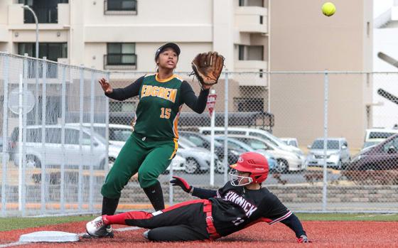 Kinnick's Blakely Rankin slides in safely at third base ahead of the throw to Edgren's Cinfani Davis.