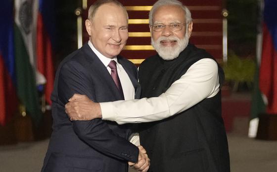 FILE - Russian President Vladimir Putin, left, and Indian Prime Minister Narendra Modi greet each other before their meeting in New Delhi, India on Dec. 6, 2021. Modi on Monday begins a two-day visit to Russia that is his first since Moscow sent troops into Ukraine, a conflict that has complicated the relationship between the longtime allies by pushing Russia closer to India's rival China. 