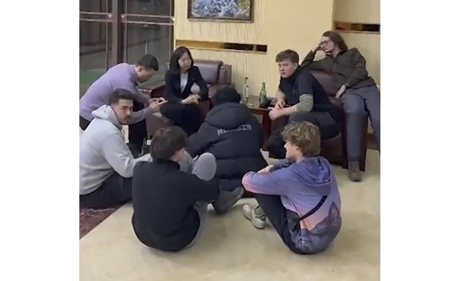 A tourist group receives a briefing from a North Korean host at a hotel.