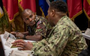 Kenyan army Lt. Col. Moses Mdzomba speaks with a U.S. Navy sailor Sept. 16, 2024, during a U.S. Army Southern European Task Force, Africa medical training planning session in Vicenza, Italy.