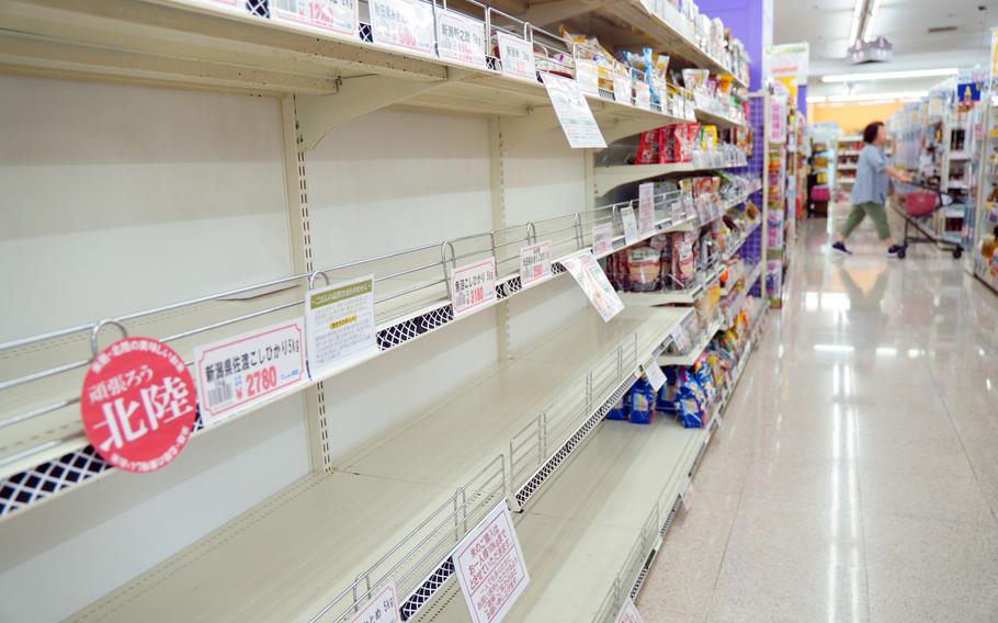 Shelves that normally stock bags of white rice were empty at a supermarket in Yokohama, Japan, Wednesday, Aug. 28, 2024.