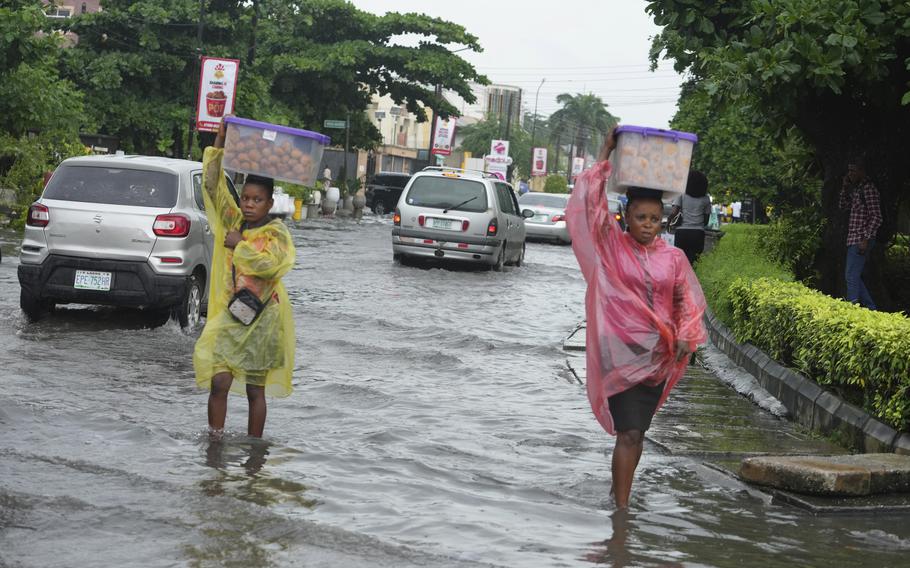 Women walk along a flooded street