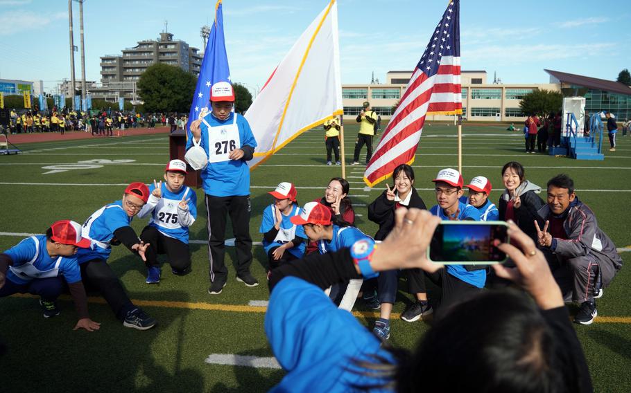 Athletes and volunteers pose for a picture before competing.