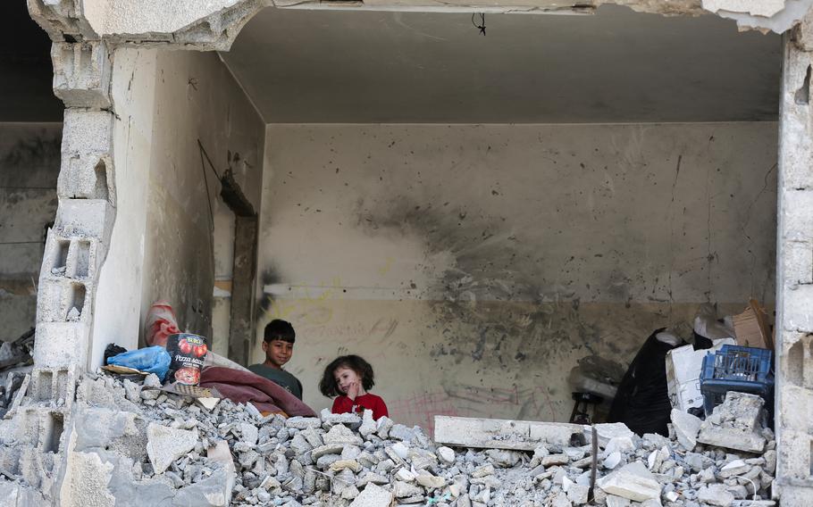 Palestinian kids stand in a house destroyed by an Israeli strike amid the ongoing conflict between Israel and the Palestinian Islamist group Hamas, in Rafah, southern Gaza Strip, on May 22, 2024. 