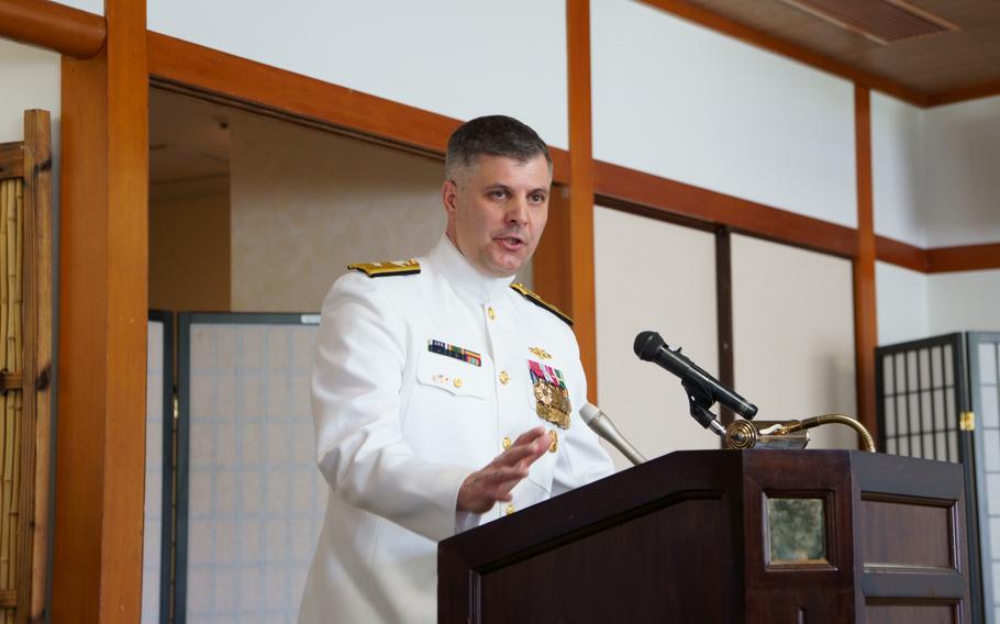 Rear Adm. Ian Johnson speaks with reporters after assuming command of U.S. Naval Forces Japan and Navy Region Japan at Yokosuka Naval Base, Japan, June 26, 2024.