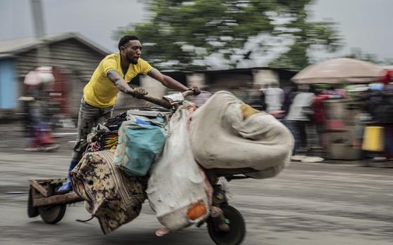 People displaced by the fighting with M23 rebels make their way to the center of Goma, Democratic Republic of the Congo, Sunday, Jan. 26, 2025. (AP Photo/Moses Sawasawa)