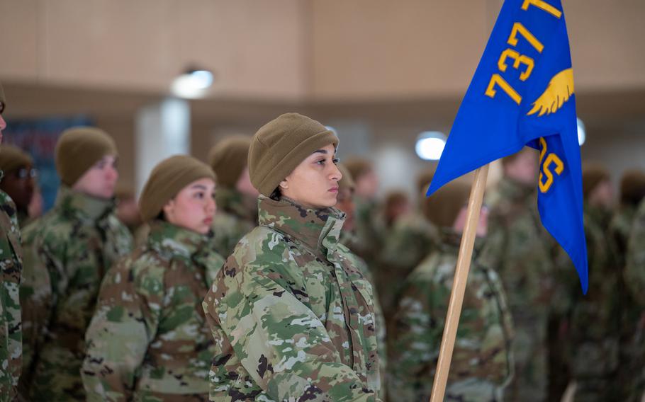 Airman Anita Alvarez holds the guidon