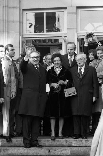 U.S. Secretary of State Henry Kissinger stands on the steps of Fuerth’s City Theater with his mother Paula and father Louis by his side on Dec. 15, 1975. Fuerth’s Lord Mayor Kurt Scherzer stands in the row behind them. Kissinger visited his former hometown in Germany to receive the Golden Citizen’s Medallion.  The Kissinger family left the Bavarian town in 1938 after Mr. Kissinger’s father, Louis Kissinger was forced to quit his job as Jews were barred from teaching positions across Germany. The elder Kissinger, his wife and two children fled to the United States. 
