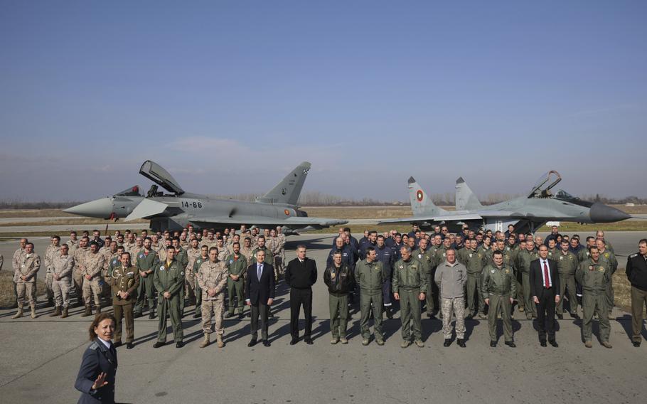 Bulgarian and Spanish Air Forces’ personnel stand in front of two aircraft.