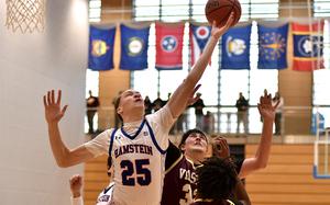 Ramstein center Kelan Vaughn reaches for a rebound over Vilseck center John Dorff during a Division I semifinal game at the 2025 DODEA European basketball championships on Feb. 14, 2025, at the Wiesbaden Sports and Fitness Center in Wiesbaden, Germany.