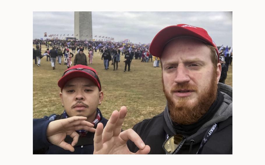 Proud Boy Brian Healion, right, poses for a selfie with Freedom Vy, left, a fellow member of the group’s Philadelphia chapter, near the Washington Monument in Washington, D.C. on Jan. 6, 2021. 