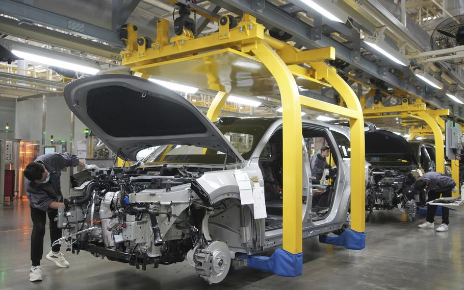 A worker assembles an SUV at a car plant of Li Auto, a major Chinese EV maker, in Changzhou in eastern China’s Jiangsu province, March 27, 2024.