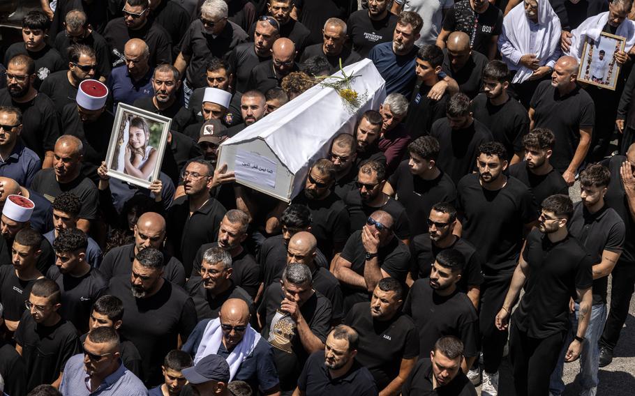 Thousands of people from the Druze community in Israel attend the funeral of 10 children and teenagers killed in July by a rocket attack from Lebanon. 