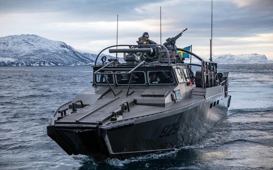 A Swedish CB90-class fast assault boat approaches the dock landing ship USS Gunston Hall during exercise Steadfast Defender on March 6, 2024. The Swedish military will participate in the annual BALTOPS exercise for the first time as a NATO member.