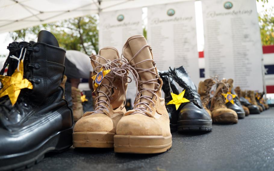 Boots representing fallen sailors are displayed during the Bells Across America ceremony at Yokosuka Naval Base, Japan, Thursday, Sept. 19, 2024.