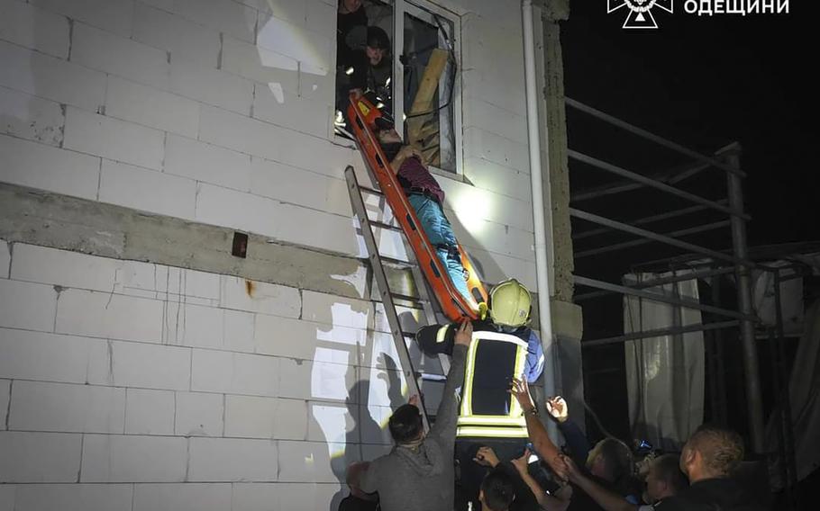 In this photo provided by the Ukrainian Emergency Service, Emergency workers carry a wounded resident after Russian missile attack in Odesa, Ukraine, late Thursday, Oct. 10, 2024.