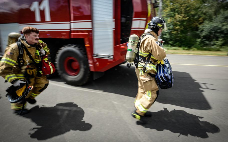 Firefighters assigned to the 86th Civil Engineer Group respond to a real medical emergency call involving an unconscious base employee at Ramstein Air Base, Germany, July 26, 2022. The first responders answered the emergency call in the midst of an ongoing simulated aircraft crash exercise scenario.