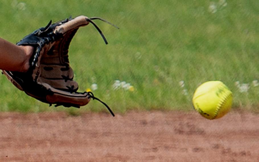 Someone fields a softball.