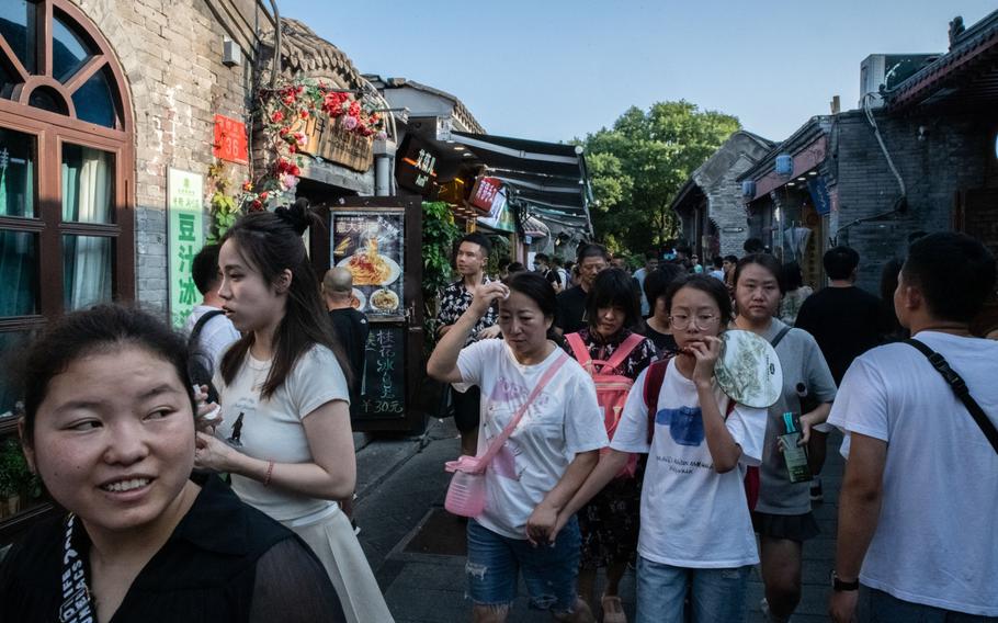 Visitors in Nanluoguxiang, an alleyway popular with tourists, in Beijing.