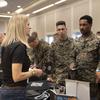 Robyn Cameron, a Recruitment Specialist with Southeast Lineman Training Center, speaks with U.S. Marines during a SkillBridge expo at Camp Lejeune, N.C., in February 2023.