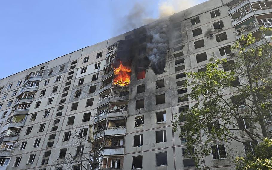 Flames are shown at a residential building in Kharkiv, Ukraine, after it was struck by a Russian aerial bomb