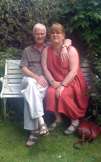 Tim Bushe with his wife, Philippa, in 2009. Philippa, who died in 2017, asked him to shape his first hedge about 15 years ago. Bushe attempted to turn the hedge into a cartoon cat, but he found it too tricky. Instead, using an electric hedge trimmer, he turned the rectangular bush into a cylinder, and then into a steam train.