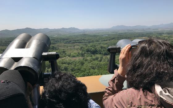 Tourists look across the Demilitarized Zone at North Korea during a visit to Dora Observatory, May 24, 2017.