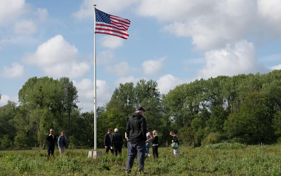 Relatives of a B-17 bomber crew, whose plane called Spare Charlie was shot down by Nazis during World War II, visit the site of the crash in Épagne-Épagnette, France, Saturday, June 22, 2024. An American flag was recently erected at the site. 