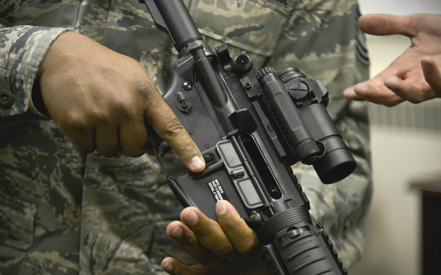 An airman ensures the chamber of an M4 carbine assault rifle is clear on April 6, 2015, at Fairchild Air Force Base, Wash. Shawn Robson, a noncommissioned officer in charge of the base’s Combat Arms Training Management section, was sentenced in federal court Wednesday to probation after he cooperated with investigators.