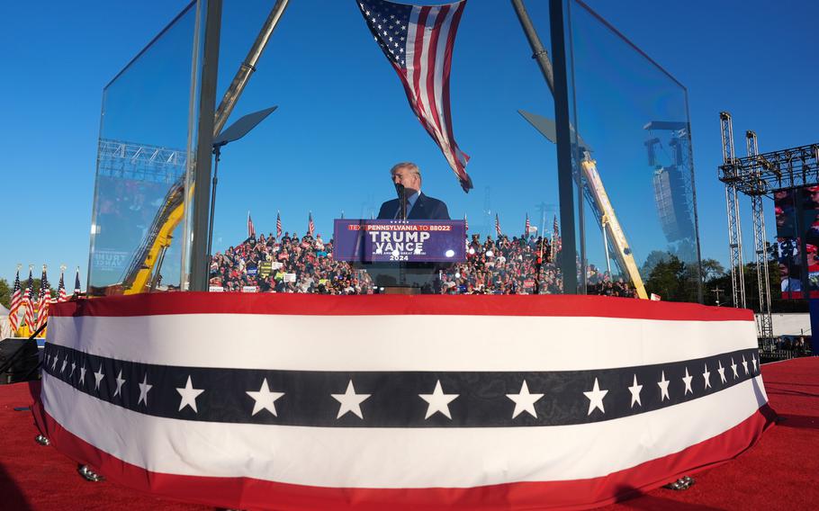 Trump speaks from behind bullet-resistant glass during a campaign event in Butler, Pa., on Oct. 5. 