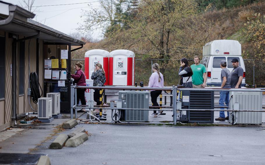 People stand in line Friday for early voting at the Yancey County Board of Elections office in Burnsville, N.C. Many residents there and elsewhere in the western part of the state are still trying to recover from Hurricane Helene. 