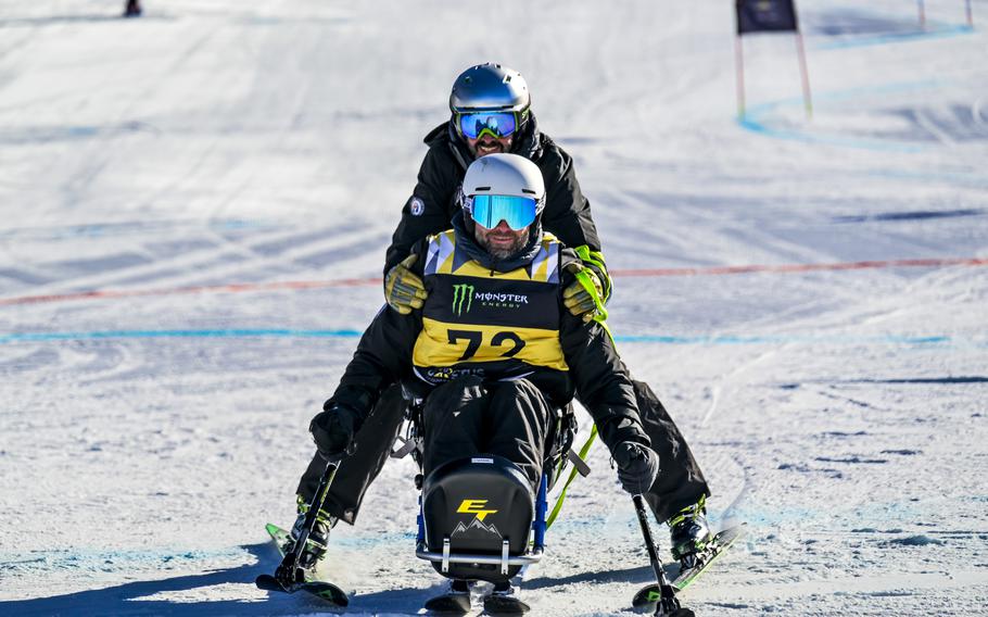 A competitor competes in the adaptive skiing event