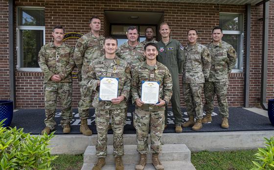 U.S. Air Force Airman 1st Class Trace Drugolenski, 347th Operations Support Squadron commanders enlisted executive, front left, and Airman 1st Class Orlando Martinez, 23rd Operations Support Squadron targeting analyst, front right, pose for a photo after receiving Air and Space commendation medals from Col. Paul Sheets, 23rd Wing commander, center, at Moody Air Force Base, Georgia, Aug. 23, 2024. While on leave in Florida, Martinez and Drugolenski came to aid a drowning victim that ultimately saved his life. (U.S. Air Force photo by Senior Airman Leonid Soubbotine)