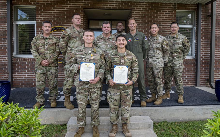 U.S. Air Force Airman 1st Class Trace Drugolenski, front left, and Airman 1st Class Orlando Martinez, front right, pose for a photo after receiving Air and Space commendation medals