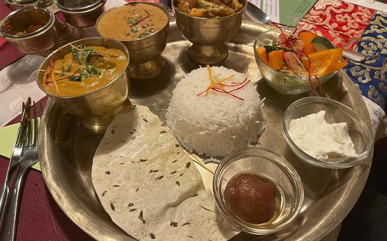 Namaste Nepal in Wiesbaden, Germany, offers sampler platters known as thalis. This one has three entrees along with rice, salad and a dessert.