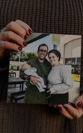 Chava Landau Zenilman holds a photo of herself with husband, Ari, and their baby daughter. 