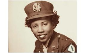 A black-and-white photo of a woman in a 1940s Army nurse uniform.