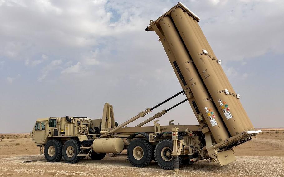 An Army air defense vehicle is parked in desert terrain.