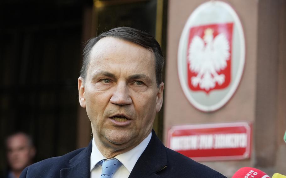 Poland’s Foreign Minister Radek Sikorski talks to the media outside the Foreign Ministry in Warsaw, Poland, Tuesday, Oct. 22, 2024. 