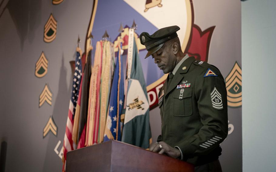 Command Sgt. Maj. Errol Brooks speaks at a podium for the 75th anniversary ceremony for the 7th Army NCO Academy.