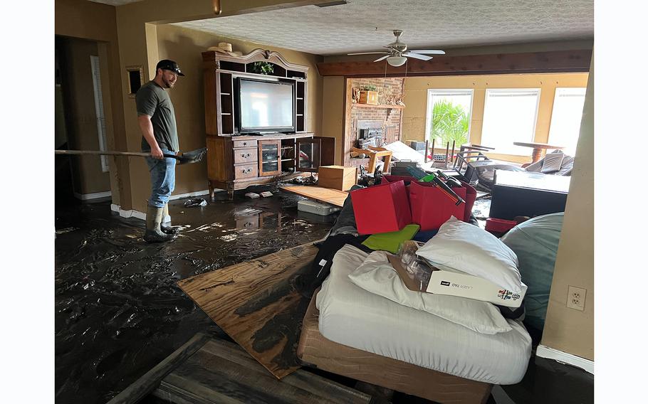 Todd Mitchell, 39, cleans up his flooded home in Steinhatchee, Fla., on Aug. 31, 2023.