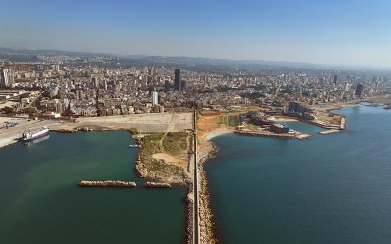 A crossing over the sea stretches into a skyline.