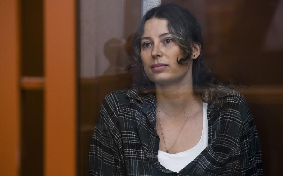 Ksenia Karelina sits in a defendant's cage during a court appearance in Yekaterinburg, Russia, on June 20, 2024.