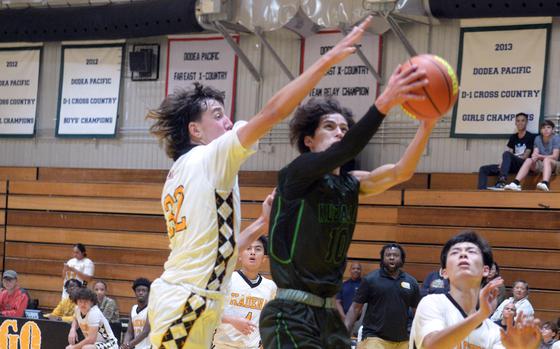 Kubasaki's Troy Harris shoots against Kadena's Mark Francis.