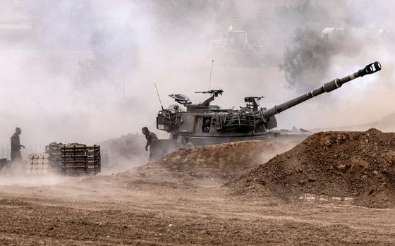 Israeli forces fire at Hamas militants near the Gaza border in October 2023.